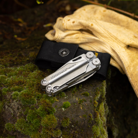 wave on a stump next to a sheath and a pair of gloves