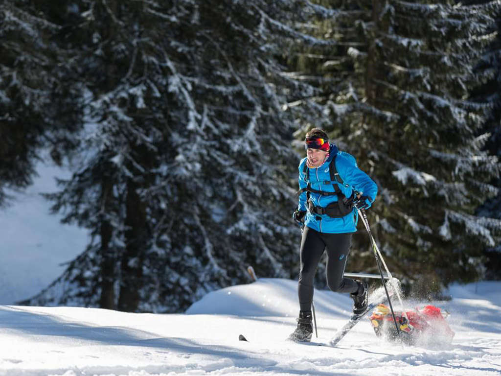 Man running with sled during winter